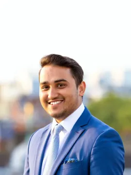 Official portrait of Pradeep Singh wearing a blue suit